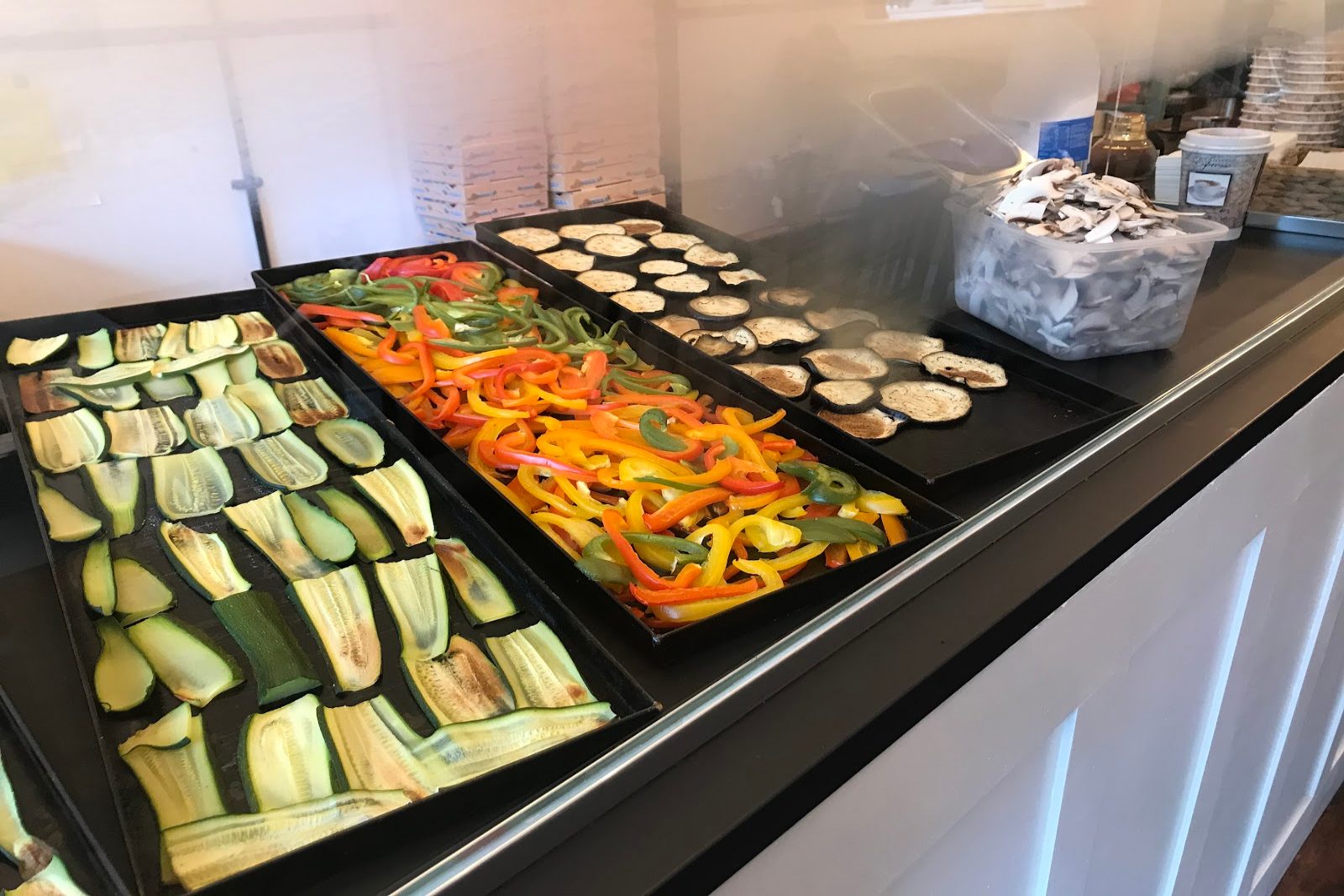 Trays of grilled courgette, peppers and aubergine on Ciamei's deli counter